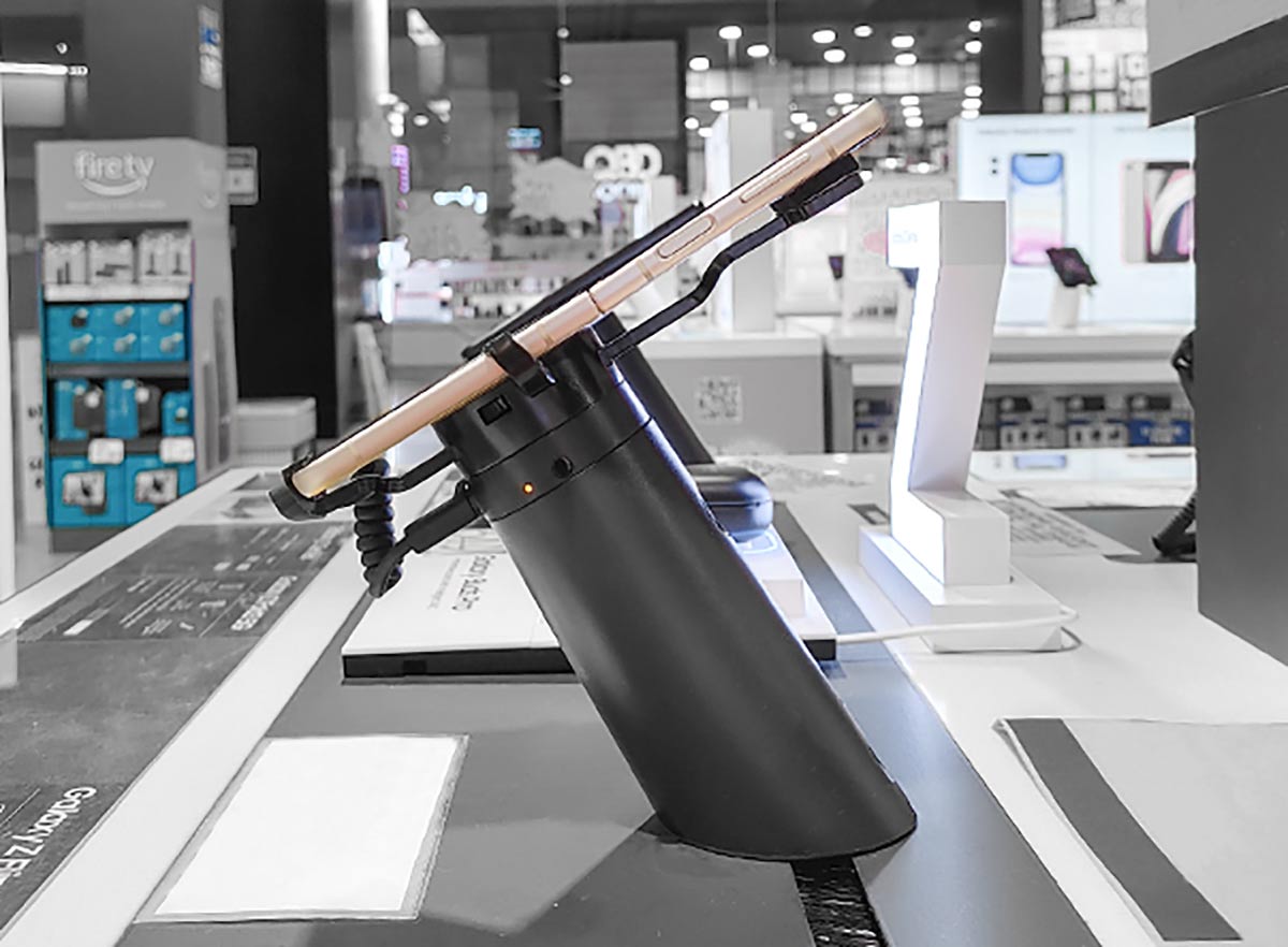 Samsung galaxy flip 3 phone, secured onto a custom security bracket attached to a black OnePOD by InVue