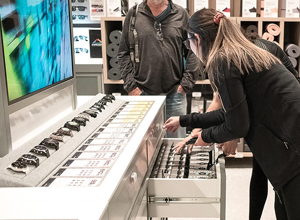 rebel highpoint melbourne, employee has opened drawer and assisting customer with smart watches
