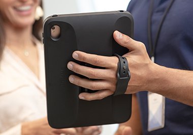 mpos and tablet stands, sales person holding tablet stand showing customer