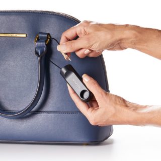 IR cable lock, being attached to handbag handle, alarmed, apparel security tag, clothing store