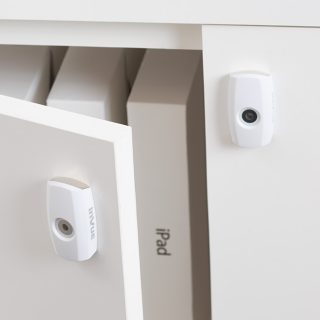 white cam lock, smart lock, open cupboard with ipads being protected from theft