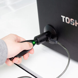 Laptop retail security, device attached to laptop, K-Lock by InVue, being unlocked by OneKEY