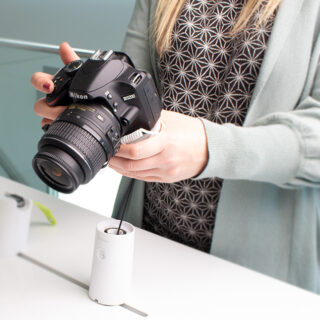 Customer holding camera, secured by OnePOD Camera solution