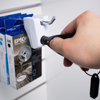 IR StopLok by InVue, hanging merchandise protection, being unlocked by OneKEY, hangsell