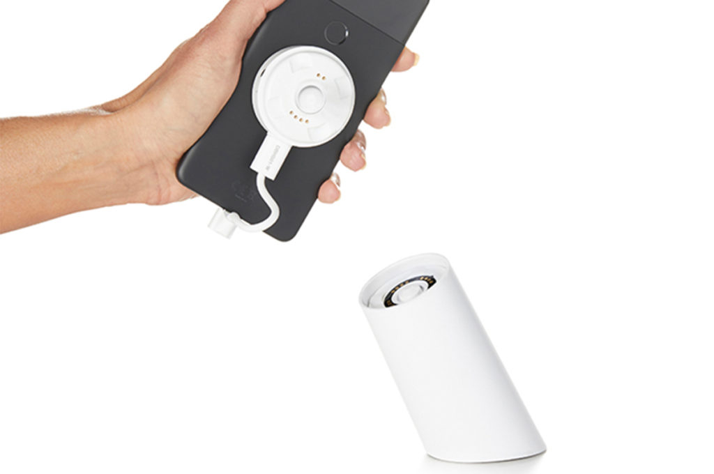 OnePOD Wireless, phone detached from stand in persons hand