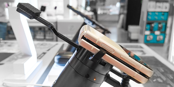 Samsung galaxy flip 3 phone, secured onto a custom security bracket by InVue