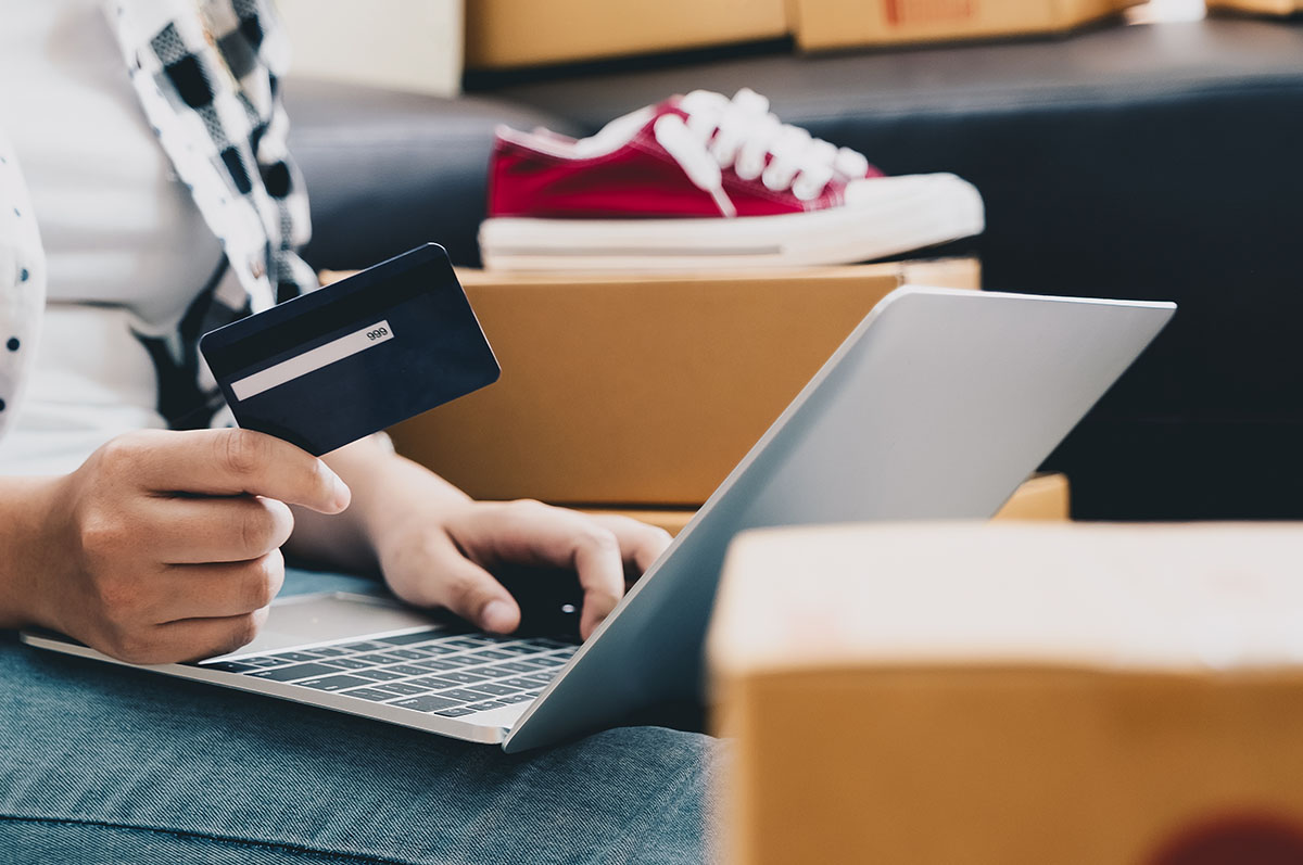 retail trends driving sales, paying with credit card on laptop