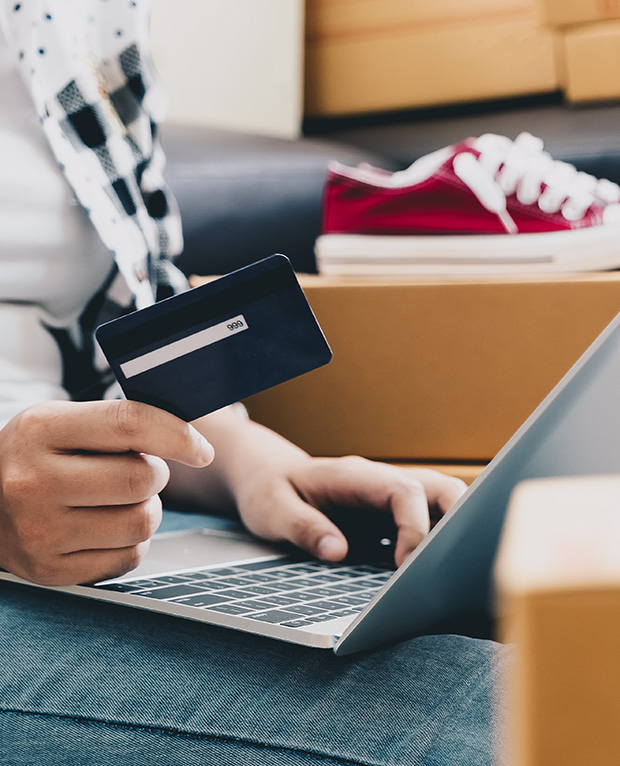 retail trends driving sales, paying with credit card on laptop