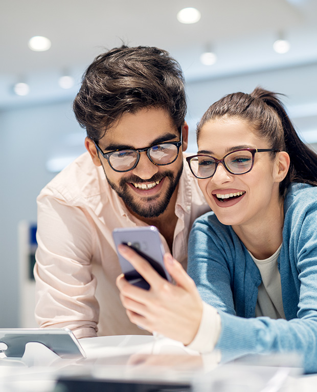 A couple looking at a phone instore, blog article