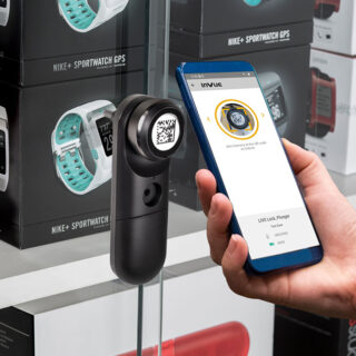 InVue Live Locks attached to glass sliding cabinets, being unlocked with mobile phone, QR code