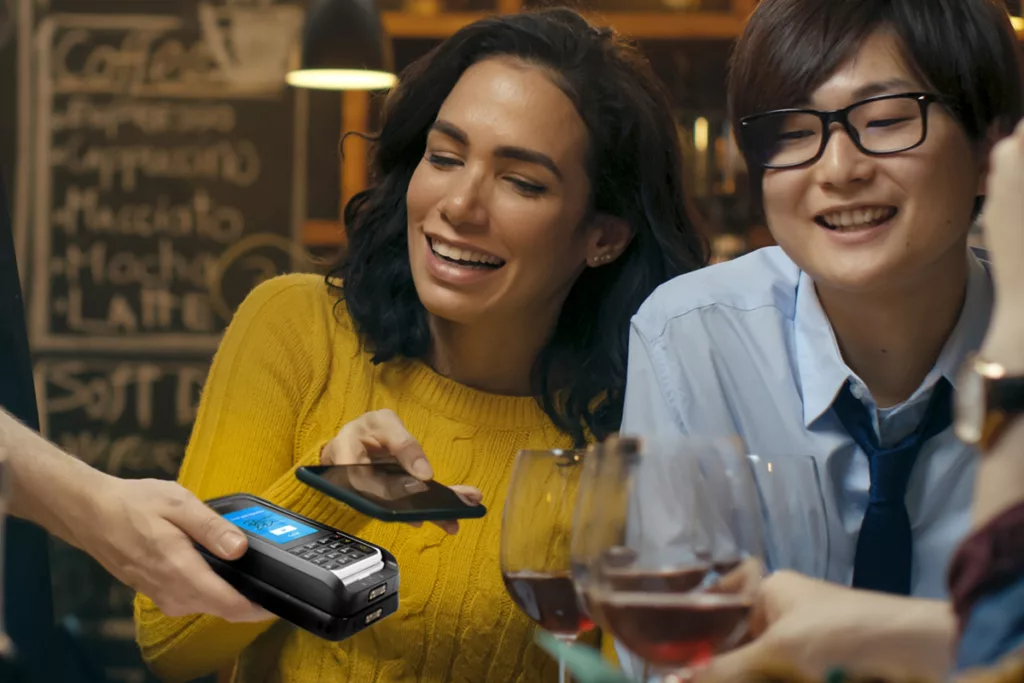 customer paying in restaurant with mobile phone